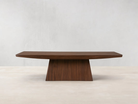 Ilaria Coffee Table with a rectangular walnut finish, featuring a wide, flat surface and tapered, sturdy base on wooden floor.