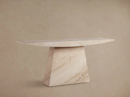 A beige marble console table with a triangular base and a sleek rectangular top, set against a neutral wall and wooden floor.