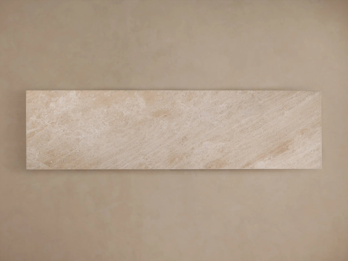 A minimalist beige stone console table with a rectangular top, featuring smooth surfaces and a geometric central pedestal base.
