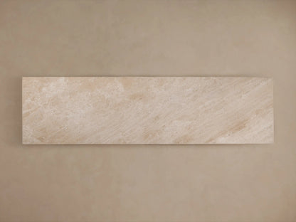 A minimalist beige stone console table with a rectangular top, featuring smooth surfaces and a geometric central pedestal base.