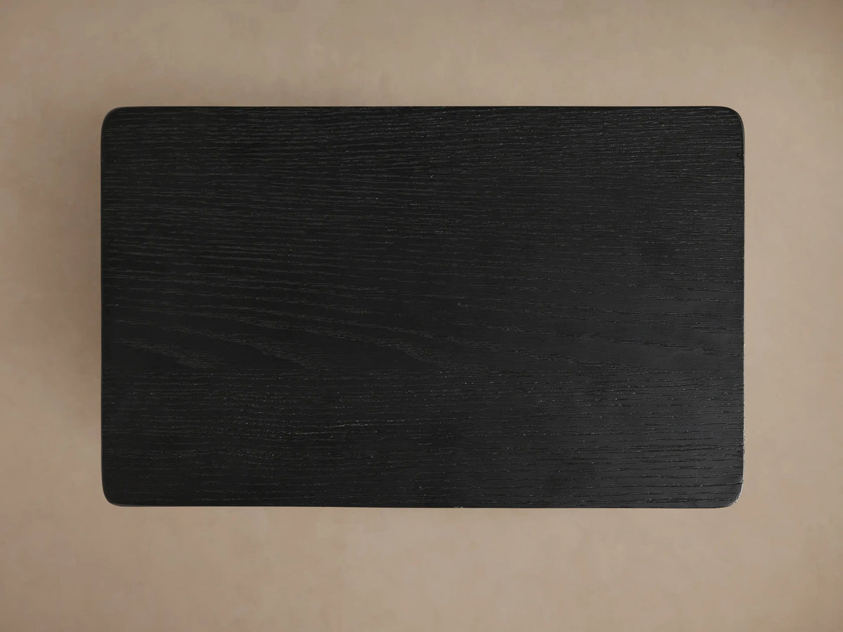 Top-down view of the rectangular ebony Iva C Table surface with visible wood grain and subtly rounded corners.
