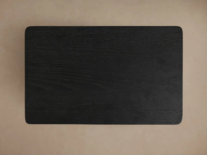 Top-down view of the rectangular ebony Iva C Table surface with visible wood grain and subtly rounded corners.