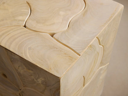 Kalmar Pedestal made of natural teak wood with visible organic shapes and cracks on its surface, standing on a wooden floor.