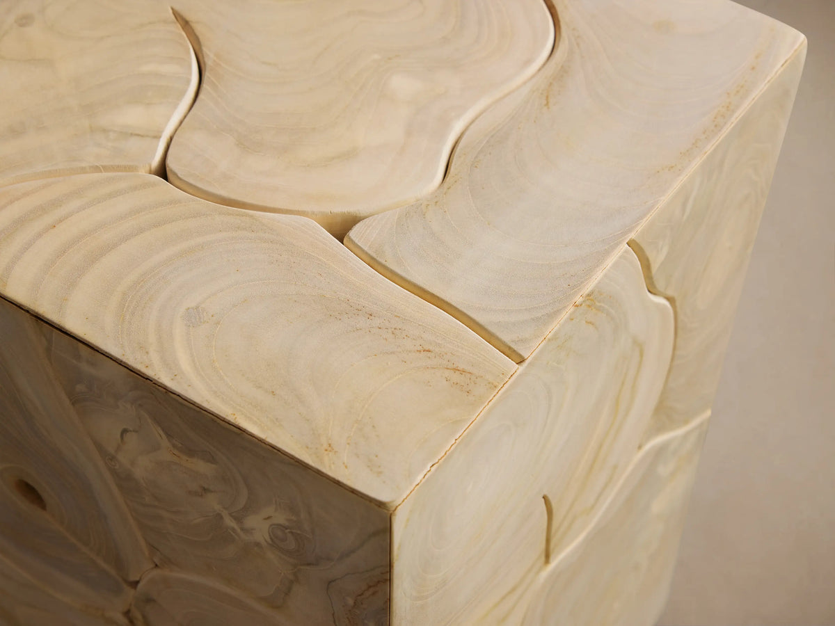 Kalmar Pedestal made of natural teak wood, showcasing organic shapes and cracks. Features a rectangular form on a wooden floor.