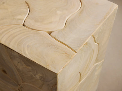 Kalmar Pedestal made of natural teak wood, showcasing organic shapes and cracks. Features a rectangular form on a wooden floor.