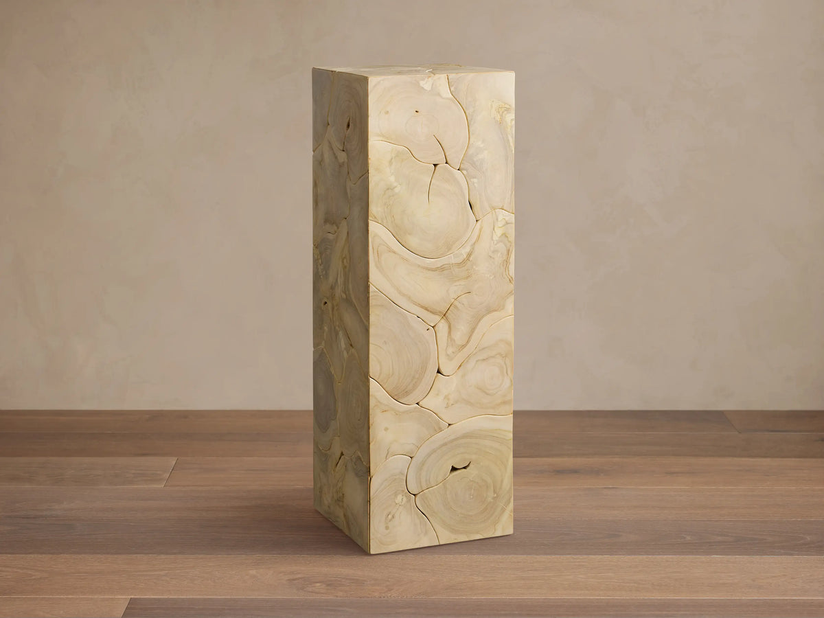 Kalmar Pedestal made of natural teak wood, with visible organic patterns, cracks, and patina, against a neutral background.