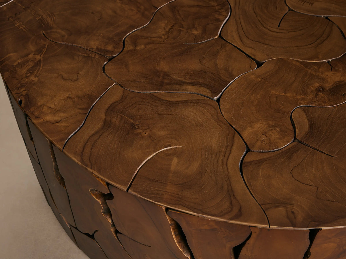 Kalmar Round Coffee Table made of teak wood with distinct organic shapes, featuring visible cracks and natural knots.
