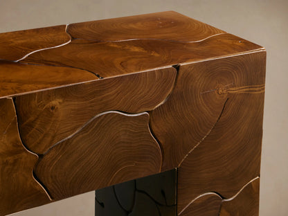 Kalmar Console Table in dark wood with a rectangular shape, featuring intricate swirling patterns on the surface, against a beige background.
