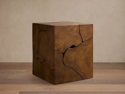 Kalmar End Table made of natural teak wood, displaying organic shapes, cracks, and unique patterns, placed on a wooden floor.