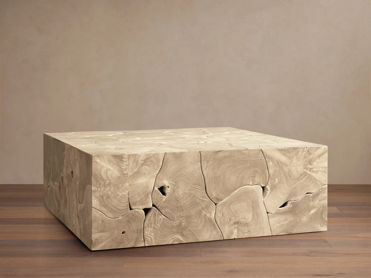 Kalmar Square Coffee Table made of natural teak wood, featuring organic shapes, cracks, and textures on a wood floor.