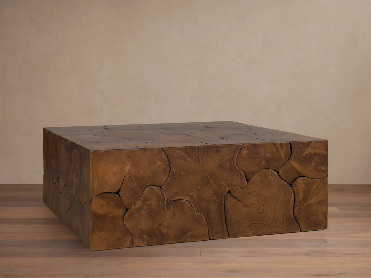 Kalmar Square Coffee Table made of natural teak wood with visible organic shapes, cracks, and patinas on its rich brown surface.