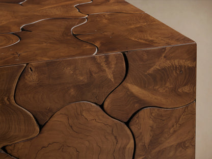 Square coffee table made from natural teak wood, featuring organic shapes, visible cracks, and distinct grain patterns on the surface.