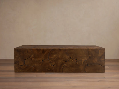 Kalmar Coffee Table made of natural teak wood with visible organic shapes, cracks, and a rich brown patina, on wooden floor.