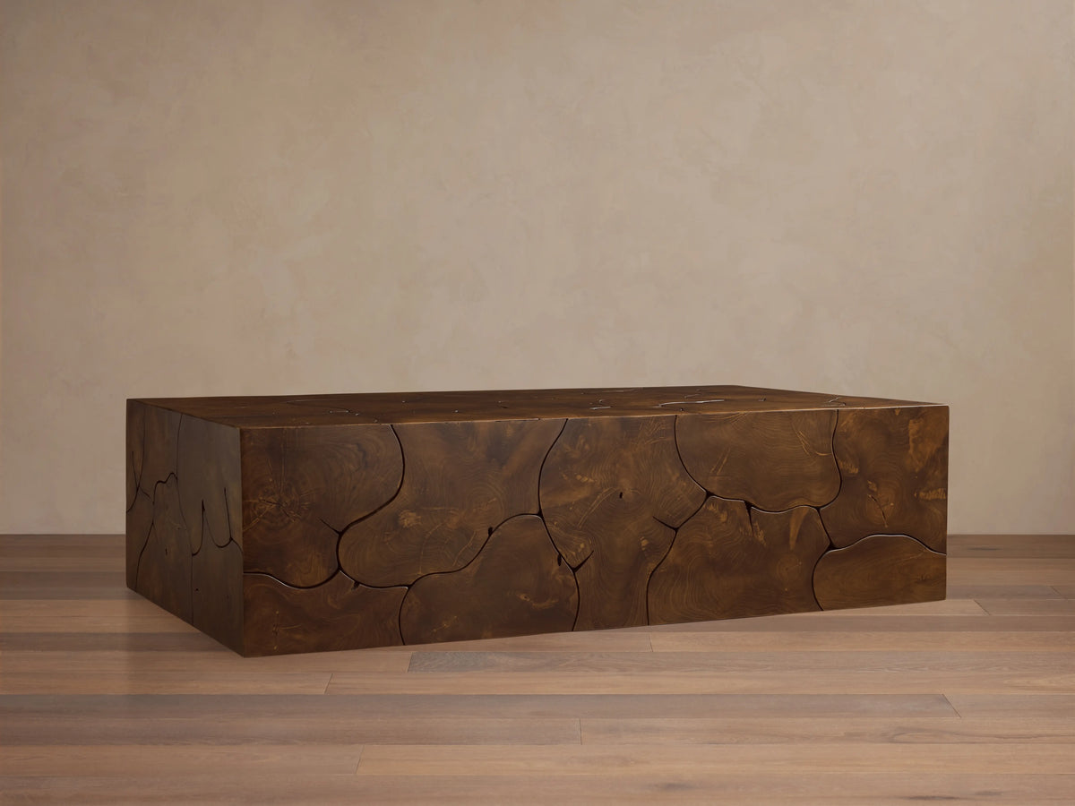 Kalmar Coffee Table made of teak wood with a smooth, glossy finish. Organic shapes and natural grain patterns visible.