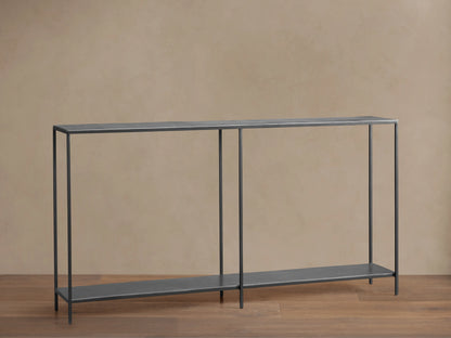 Kavali Console Table with slim black iron frame, powder-coated finish, and rectangular shape on a wooden floor.