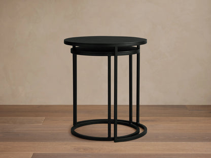 Kavali Nesting End Table with solid iron frame in black powder-coated finish. Round top with minimalist design, nested on wooden floor.
