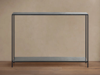 Kavali Slim Console Table with black, powder-coated iron frame, featuring a minimalistic design and slender profile against a neutral background.