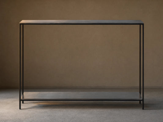 Kavali Slim Console Table with black, powder-coated iron frame, featuring a minimalistic design and slender profile against a neutral background.