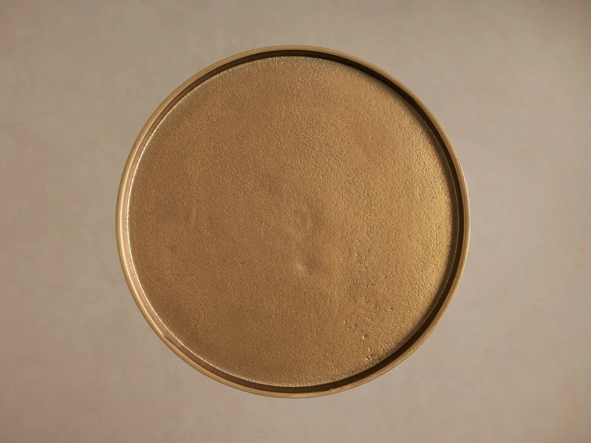 Close-up of the round, antiqued gold Kenneth Martini Tabletop, showing its textured surface and raised edge.