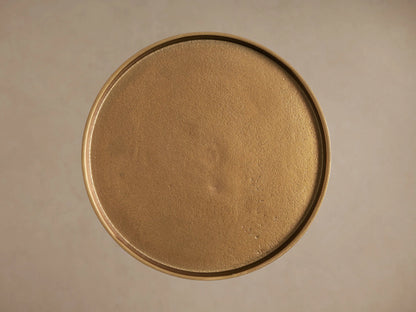 Close-up of the round, antiqued gold Kenneth Martini Tabletop, showing its textured surface and raised edge.