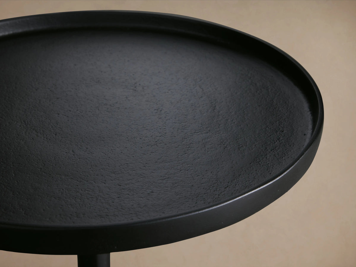 Kenneth Martini Table with a textured black surface made of cast aluminum, featuring a thin, slightly raised edge.