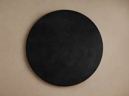 Kyoto Round Coffee Table with a sleek, dark aluminum surface. Close-up of the rounded edge, showing smooth finish and subtle sheen.