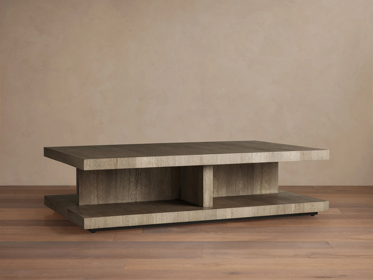 Leandro Coffee Table made of reclaimed wood, with a thick rectangular top, subtle grain, and smooth finish on wooden flooring backdrop.