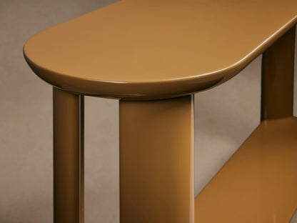 Lonny Console Table: High-gloss camel tan console with a rounded top, thick legs, and a floating lower shelf. Front view.