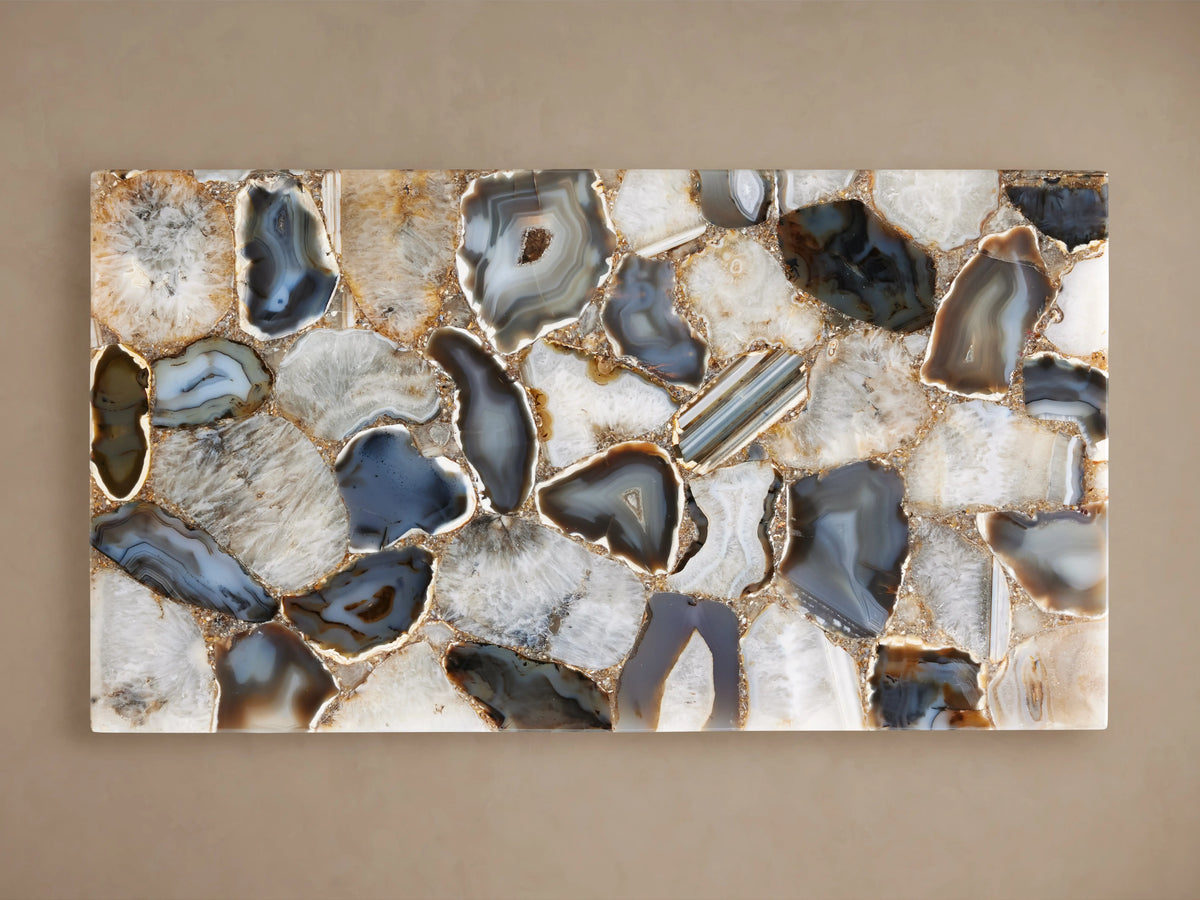 Ludlow C Table's rectangular top made of hand-arranged stones in varying blue, gray, and beige hues on a neutral background.