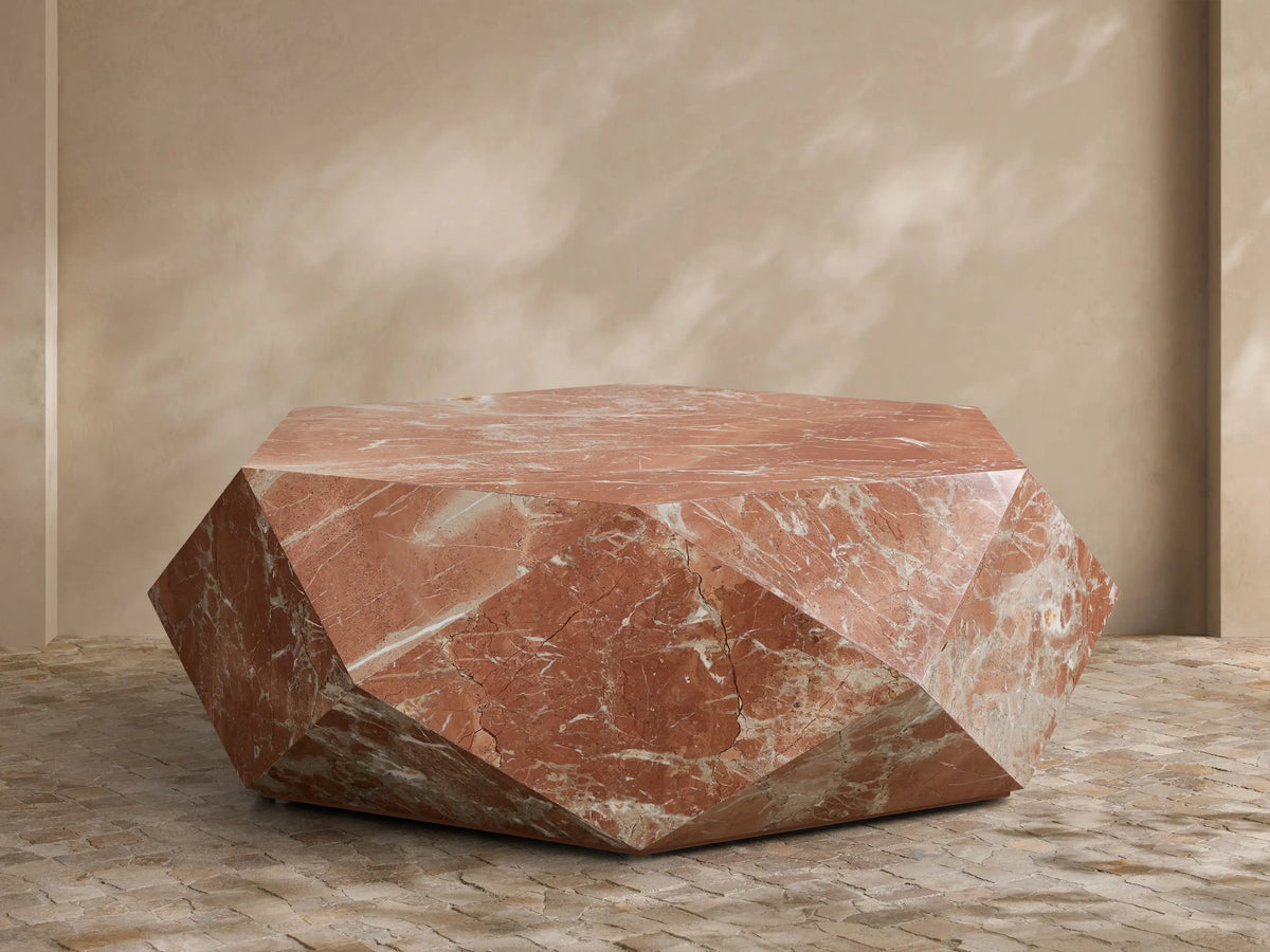 Front view of geometric faceted Rosso Levanto marble coffee table with rich red and white veining.