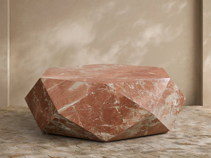 Front view of geometric faceted Rosso Levanto marble coffee table with rich red and white veining.