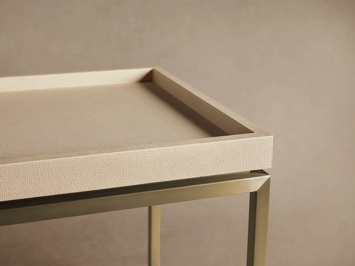Malone End Table: Square, light beige shagreen-patterned tray top on a gold metal base with an X-stretcher. Angled view.