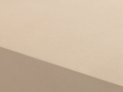 Malone Plinth Coffee Table with a textured light beige top & sides, on a thin brass-finished steel base. On wood floor.