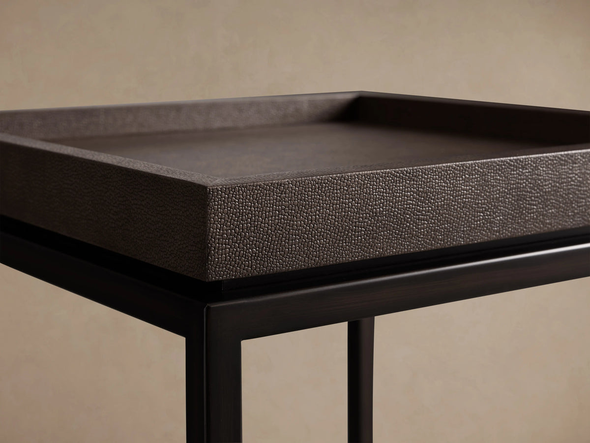 Malone End Table with a dark, embossed leather tabletop and sturdy black steel base featuring cross-brace design, set against a neutral background.