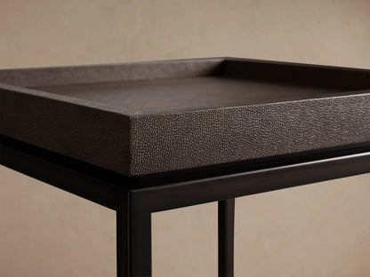 Malone End Table with a dark, embossed leather tabletop and sturdy black steel base featuring cross-brace design, set against a neutral background.