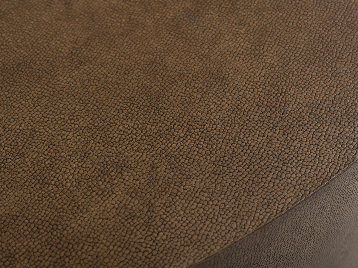 Close-up of the Malone Round Plinth Coffee Table tabletop, showcasing the brown shagreen-patterned reconstituted leather surface.