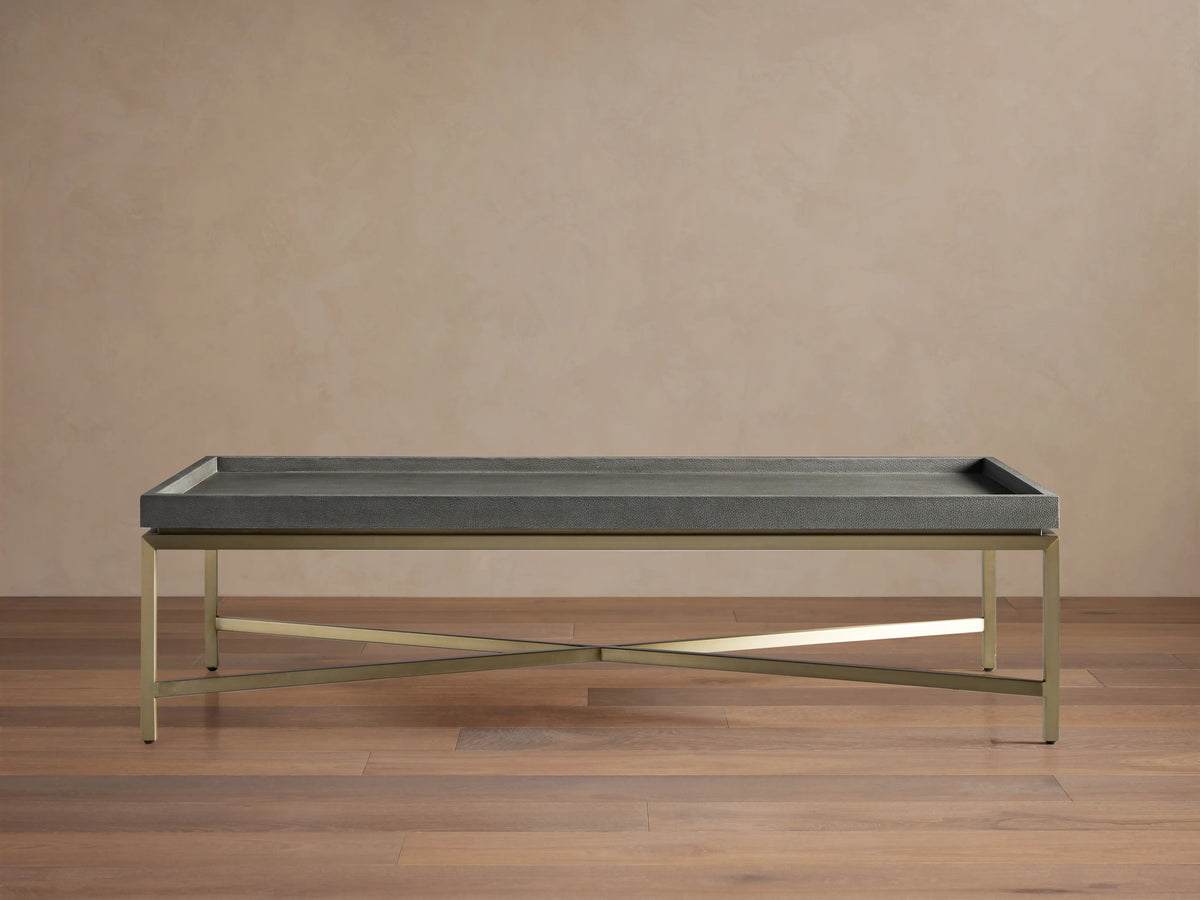 Malone Coffee Table with engineered hardwood top in shagreen pattern, reconstituted leather, and steel base, light brown floor.