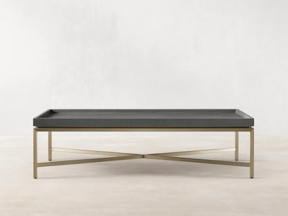 Malone Coffee Table with engineered hardwood top in shagreen pattern, reconstituted leather, and steel base, light brown floor.