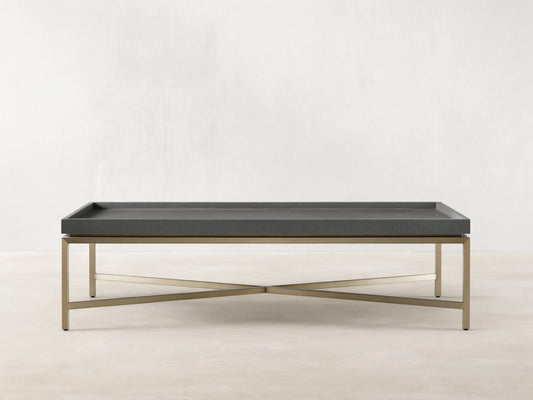 Malone Coffee Table with engineered hardwood top in shagreen pattern, reconstituted leather, and steel base, light brown floor.