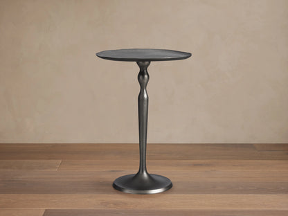 Manhattan Martini Table with a slim, elegant cast aluminum base and a round, textured tabletop, finished in dark zinc.