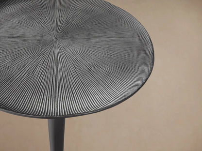 Manhattan Martini Table: Dark metallic, circular textured top, sleek hourglass pedestal, and round base, on wood floor.
