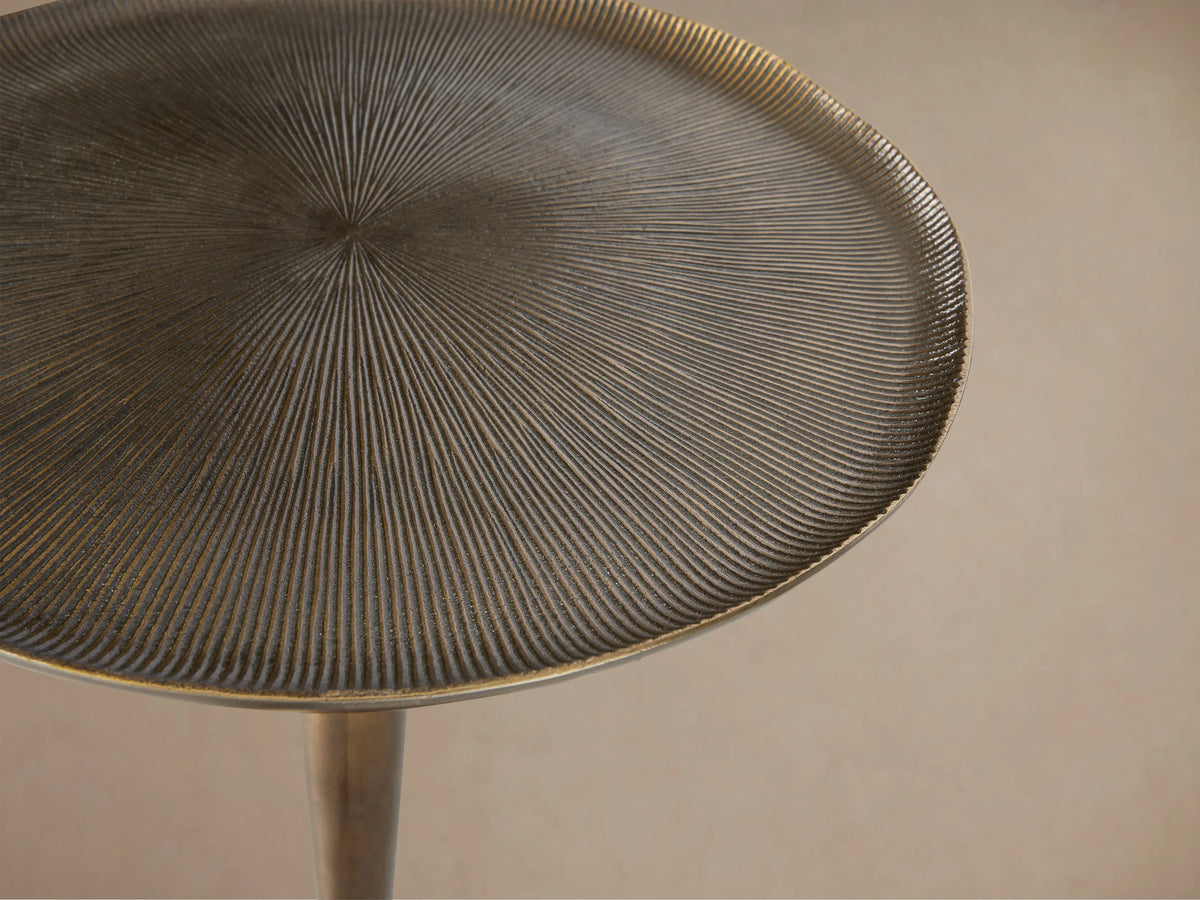 Antique bronze-toned Manhattan Martini Table with a textured, white-washed round top and a smooth, dark pedestal base.