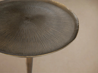 Antique bronze-toned Manhattan Martini Table with a textured, white-washed round top and a smooth, dark pedestal base.