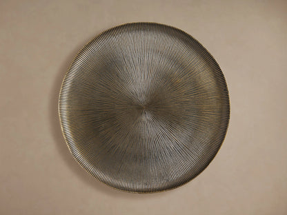 Manhattan Martini Table: Angled view of its round, dark bronze textured tabletop with radiating grooves and white-washed accents.