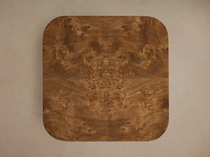 Front view of the Mogadore End Table with rich brown mappa burl veneer, featuring a top surface and an inset lower shelf.