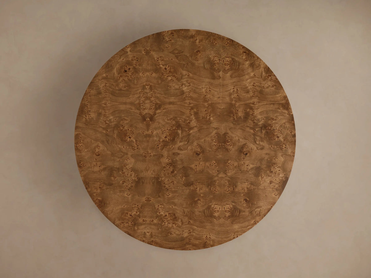 Close-up of the Mogadore Round Coffee Table, featuring two round tiers of rich brown swirling mappa burl veneer.