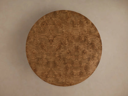 Close-up of the Mogadore Round Coffee Table, featuring two round tiers of rich brown swirling mappa burl veneer.