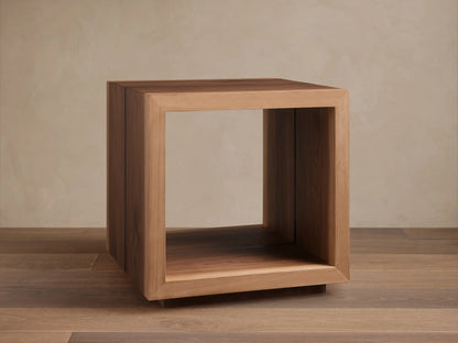Mihaela End Table, cube-shaped, made from Romanian oak with visible wood grain; open design with smooth finish, on wooden floor.