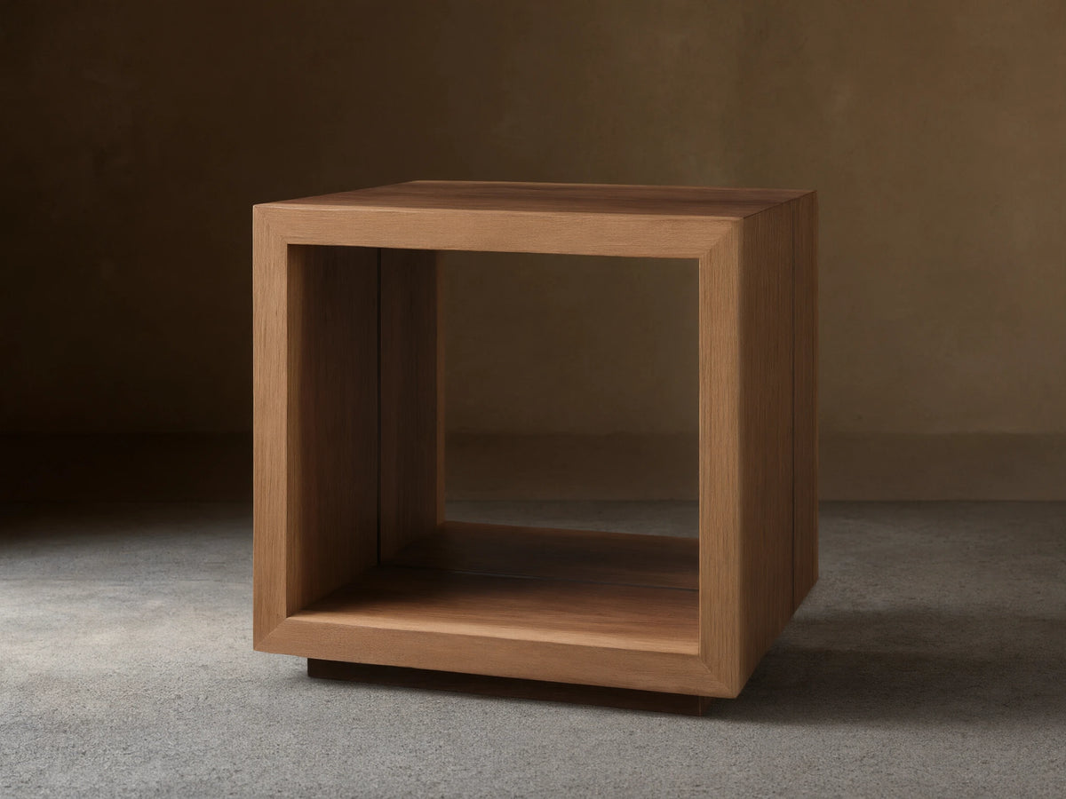 Mihaela End Table, cube-shaped, made from Romanian oak with visible wood grain; open design with smooth finish, on wooden floor.