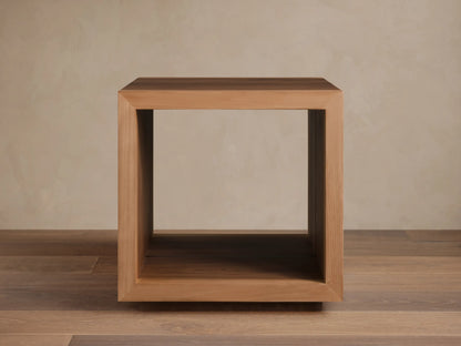 Mihaela End Table, cube-shaped, made from Romanian oak with visible wood grain; open design with smooth finish, on wooden floor.